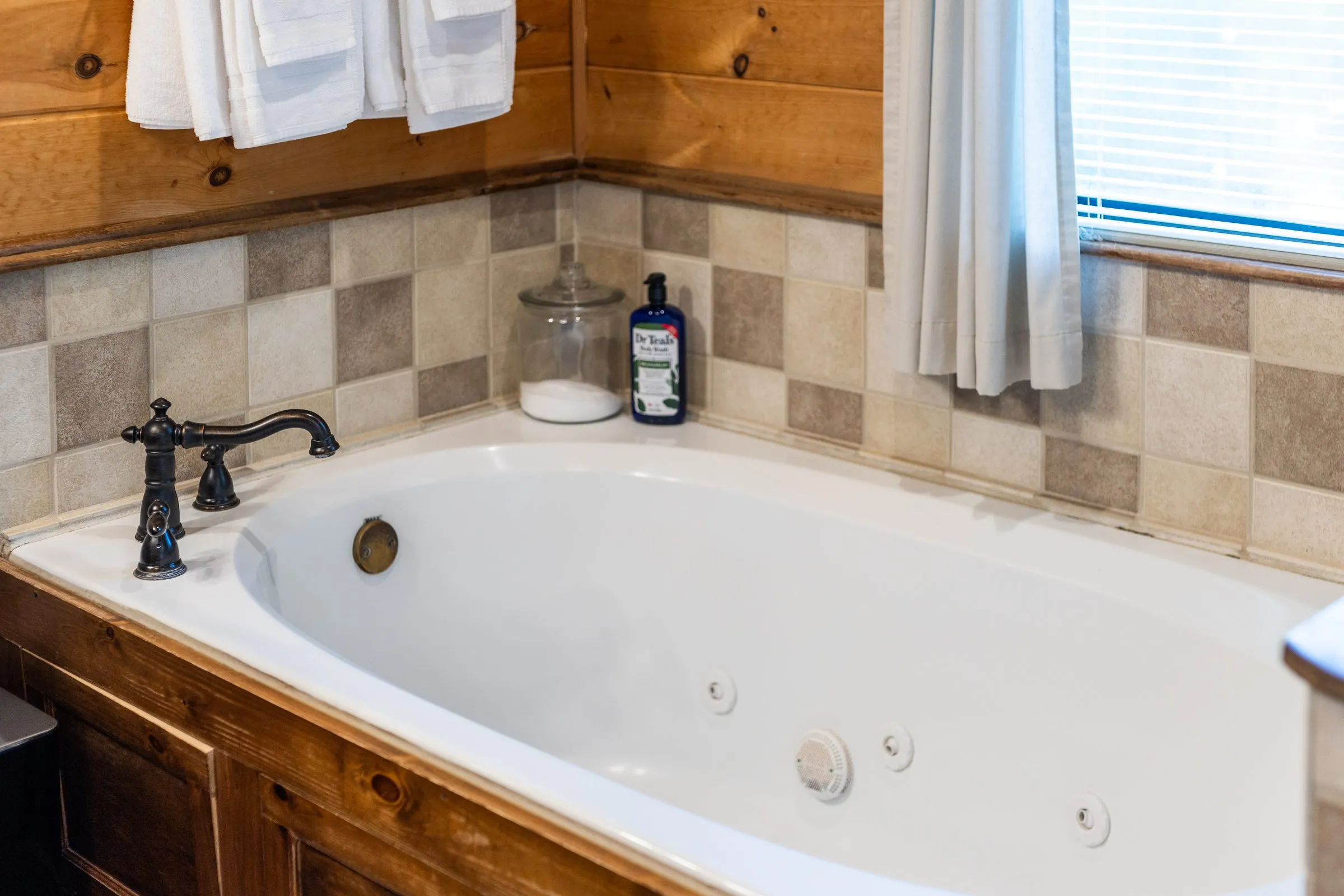 Bathroom with a jetted soaking tub and tile surround